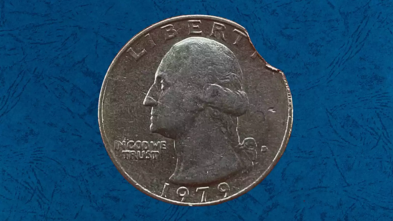 1979 quarter clipped planchet error with curved portion missing from the coin's edge